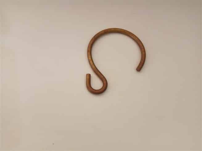 Traditional shower curtain hook shown in antique brass finish